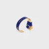 CELINE Ribbon Knotted Cuff i emalj och mässing med guldfinish CELINE Ribbon Knotted Cuff i emalj och mässing med guldfinish