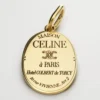 Charms CELINE-medalj i mässing med guldfinish