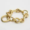 Charms Modern Thin Gourmette i mässing med guldfinish