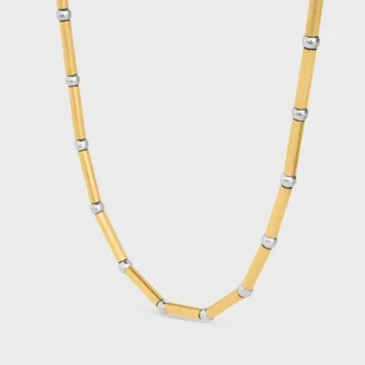 Långt halsband med berlocker i mässing med guld- och rodiumfinish Långt halsband med berlocker i mässing med guld- och rodiumfinish