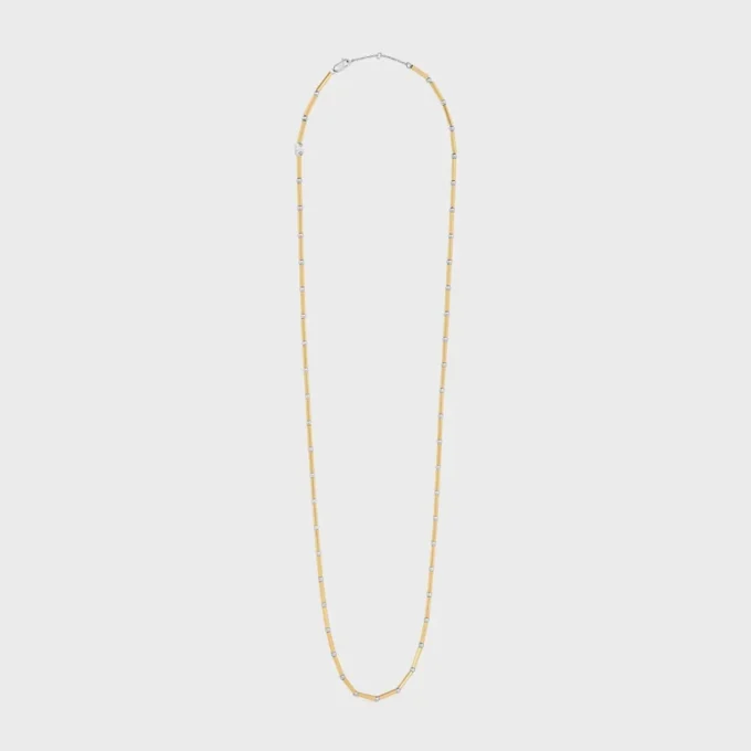 Långt halsband med berlocker i mässing med guld- och rodiumfinish Långt halsband med berlocker i mässing med guld- och rodiumfinish