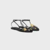 Platta sandaler med burdesign i getskinn