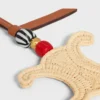 Triomphe-berlock i raffia och naturligt kalvskinn
