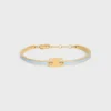 Triomphe ledat armband i emalj och mässing med guldfinish