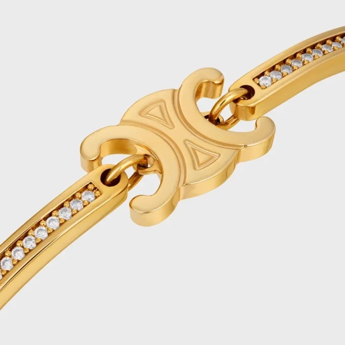 Triomphe ledat glittrande armband i strass och mässing med guldfinish