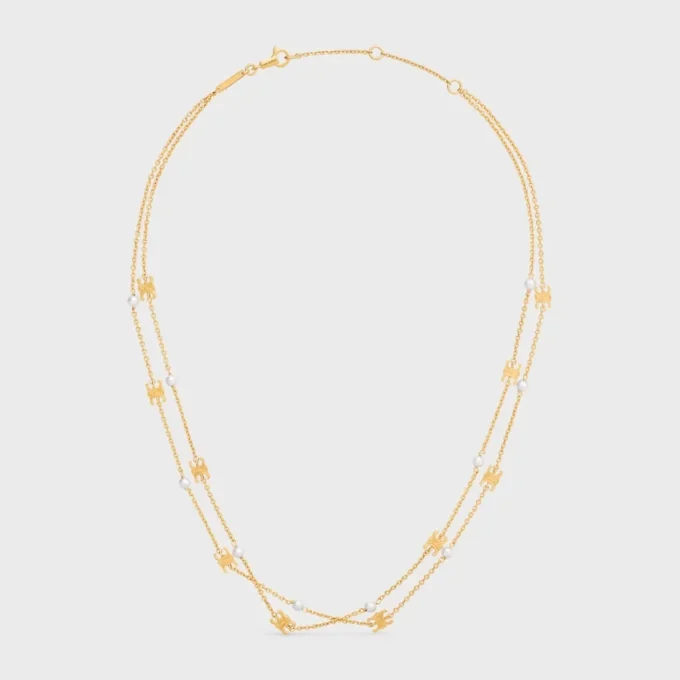 Triomphe Pearl dubbelhalsband i mässing med guldfinish och pärlor av harts Triomphe Pearl dubbelhalsband i mässing med guldfinish och pärlor av harts