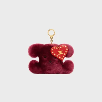 Triomphe Pom-Pom-berlock i broderat fårskinn och kalvskinn Triomphe Pom-Pom-berlock i broderat fårskinn och kalvskinn