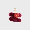 Triomphe Pom-Pom-berlock i broderat fårskinn och kalvskinn Triomphe Pom-Pom-berlock i broderat fårskinn och kalvskinn