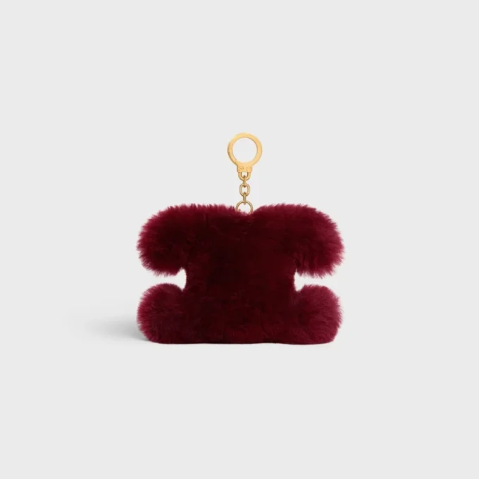 Triomphe Pom-Pom-berlock i fårskinn och kalvskinn
